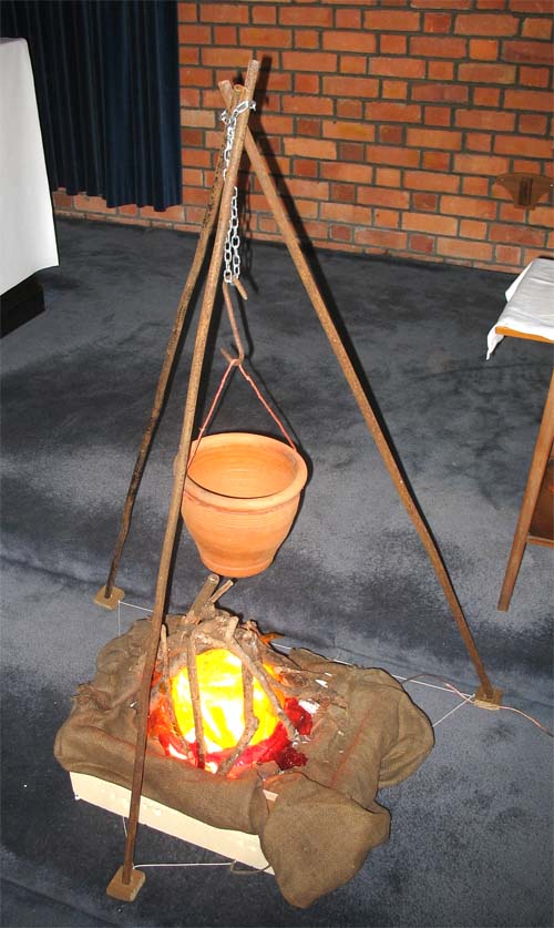 The tripod with a clay pot suspended from the apex.